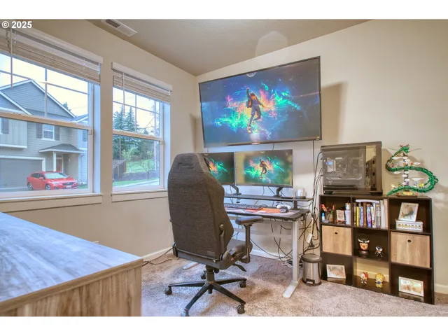 a view of a workspace with furniture and a floor to ceiling window