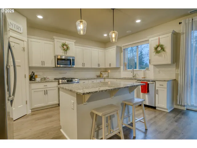 a kitchen with a sink stove and refrigerator