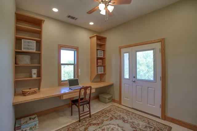 a workspace with wooden floor and a window