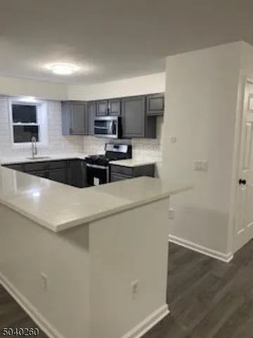 a kitchen with a sink a stove and cabinets