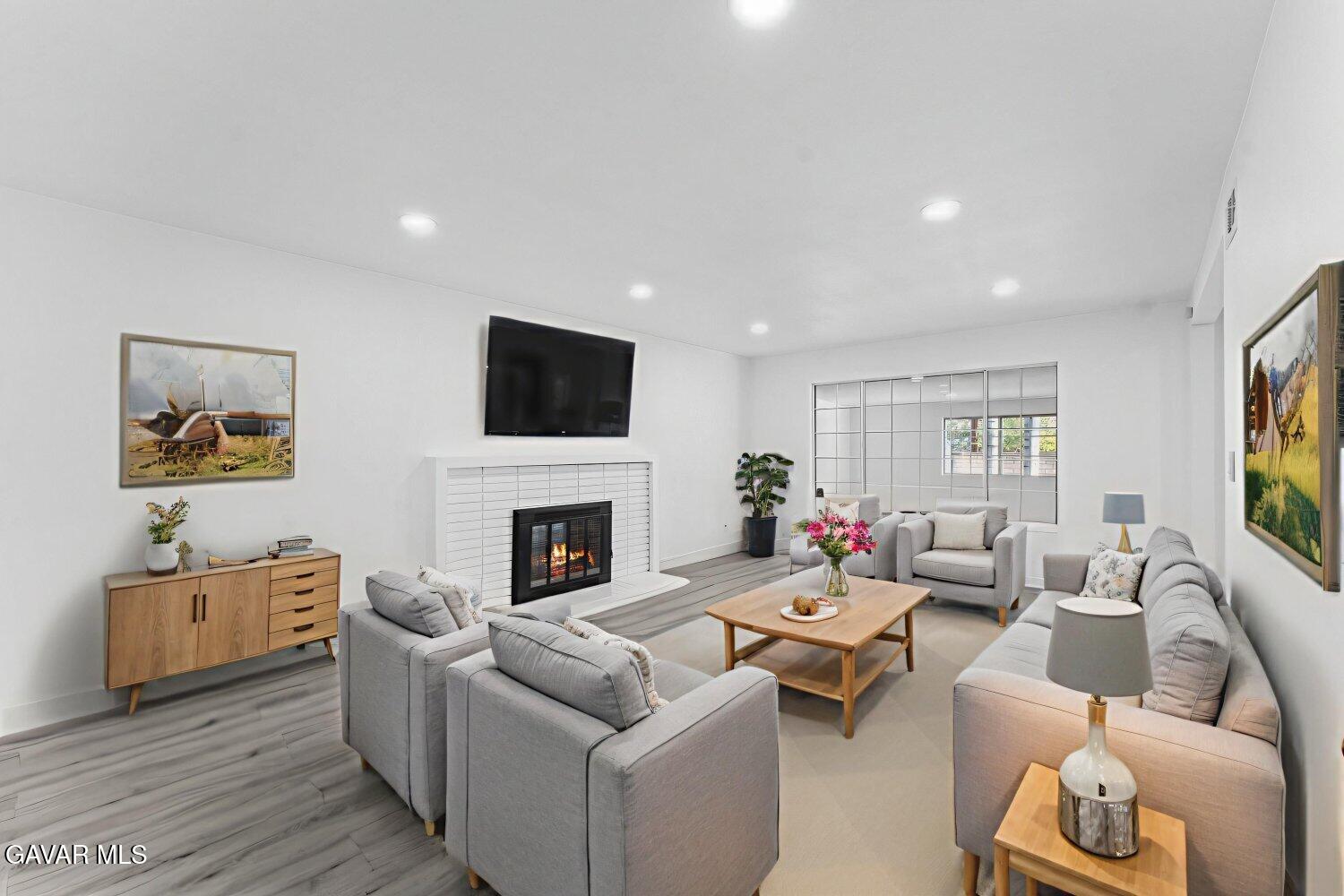 12338 Sheldon Street Sun Valley, CA 91352 - Photo 51 of 60 a living room with furniture a fireplace and a flat screen tv