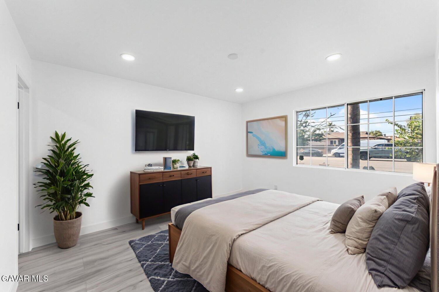 12338 Sheldon Street Sun Valley, CA 91352 - Photo 55 of 60 a bedroom with a bed and a flat screen tv