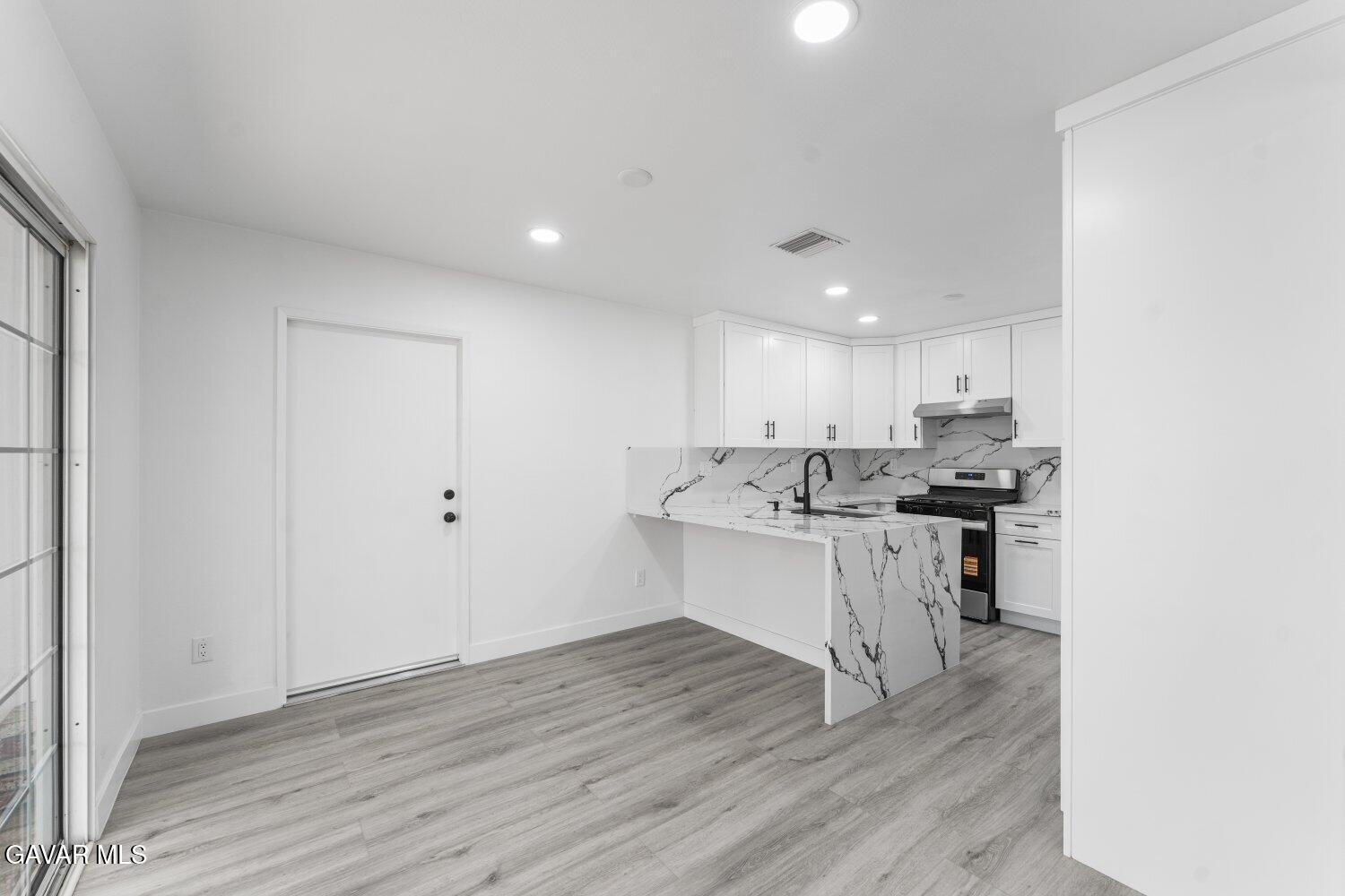 12338 Sheldon Street Sun Valley, CA 91352 - Photo 10 of 60 a kitchen with a sink cabinets and wooden floor