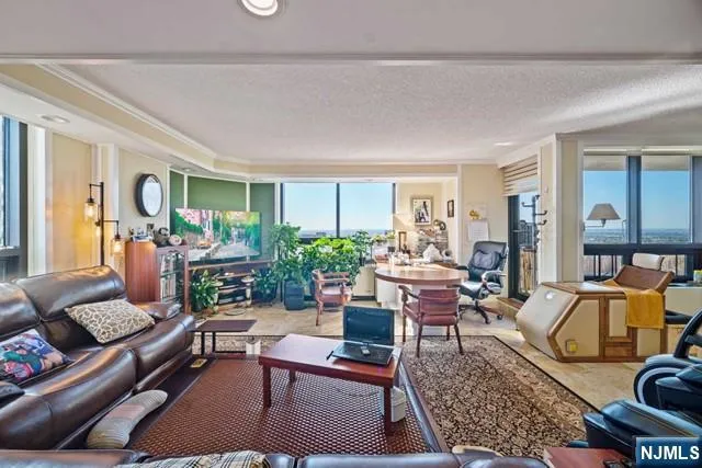 a view of a kitchen with kitchen island a counter space a sink and stainless steel appliances