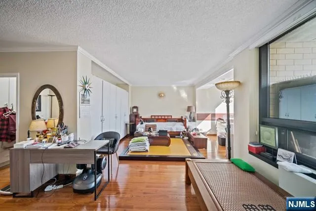 a living room with furniture large window and rug