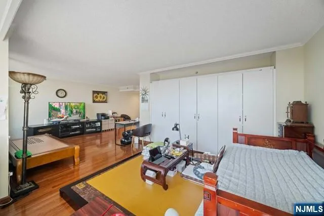 a living room with furniture and painting on the wall next to a window