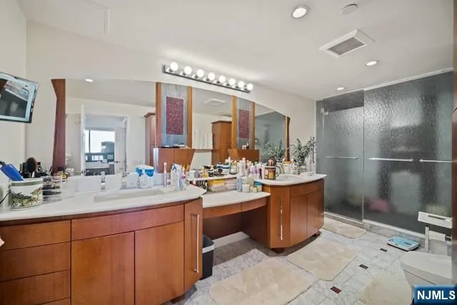 a bathroom with a sink a mirror and a shower