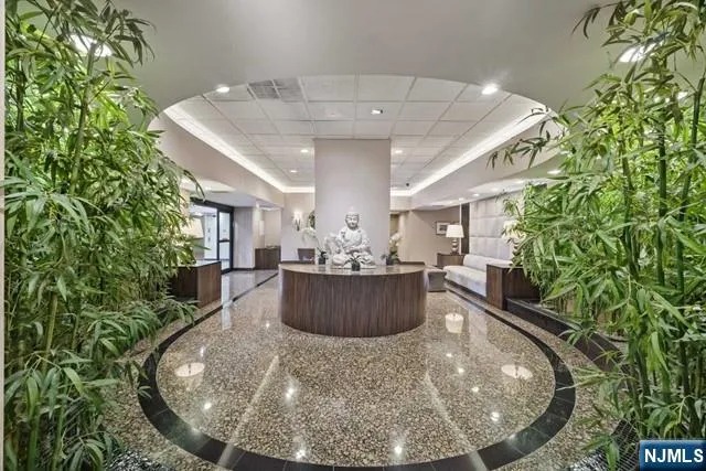 a lobby with furniture and potted plants