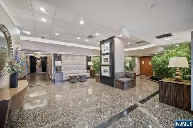 a hall with furniture and a large window