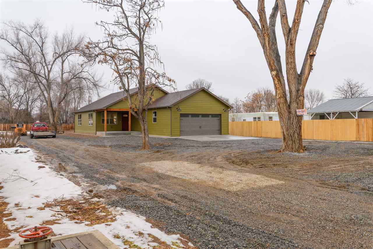 239 29 Road Grand Junction, CO 81503 - Photo 3 of 29 a front view of a house with a yard and garage