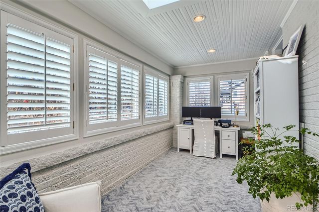a living room with furniture and large windows