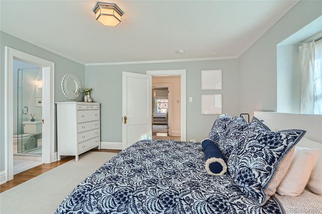 a living room with a bed and a dresser