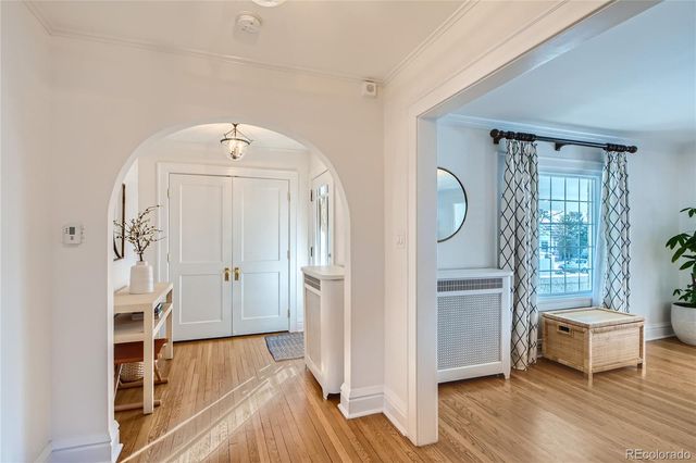 wooden floor with white walls and windows