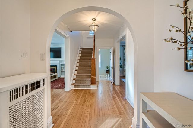 a view of a room with wooden floor and stairs