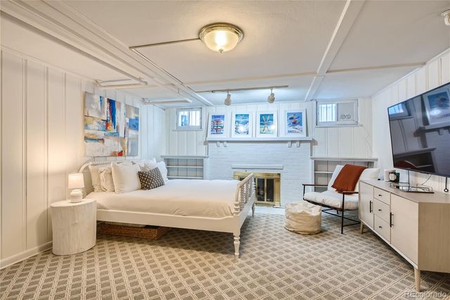 a bedroom with furniture and a fireplace