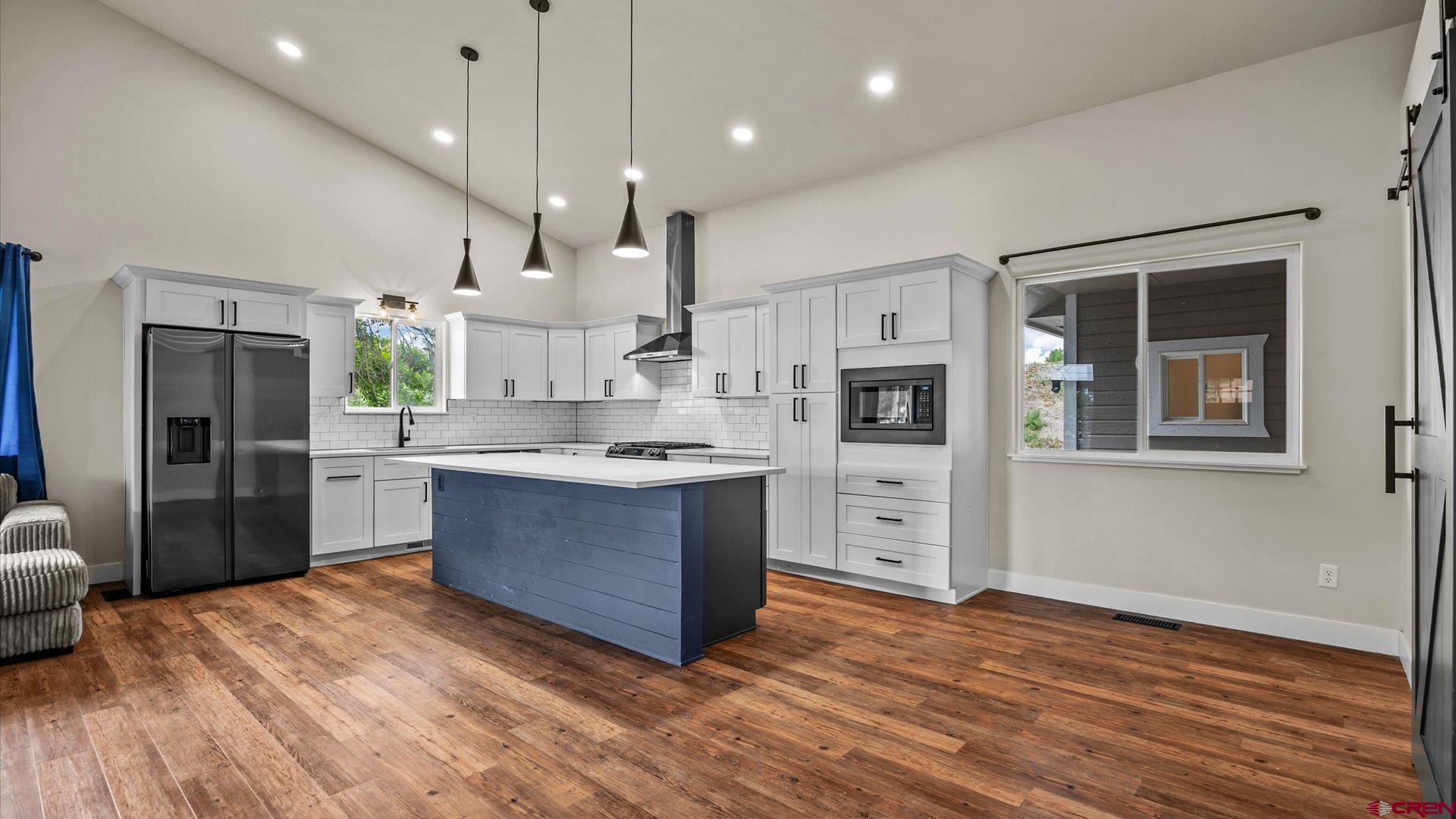 3312 East 1/4 Road Clifton, CO 81520 - Photo 19 of 43 a large kitchen with stainless steel appliances kitchen island a large counter top and a sink