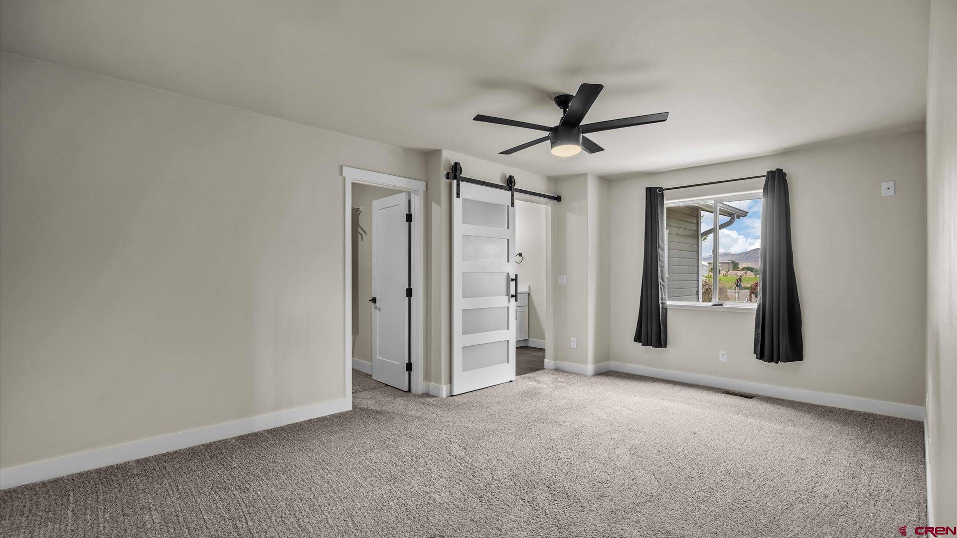 3312 East 1/4 Road Clifton, CO 81520 - Photo 22 of 43 a view of a livingroom with a ceiling fan and window