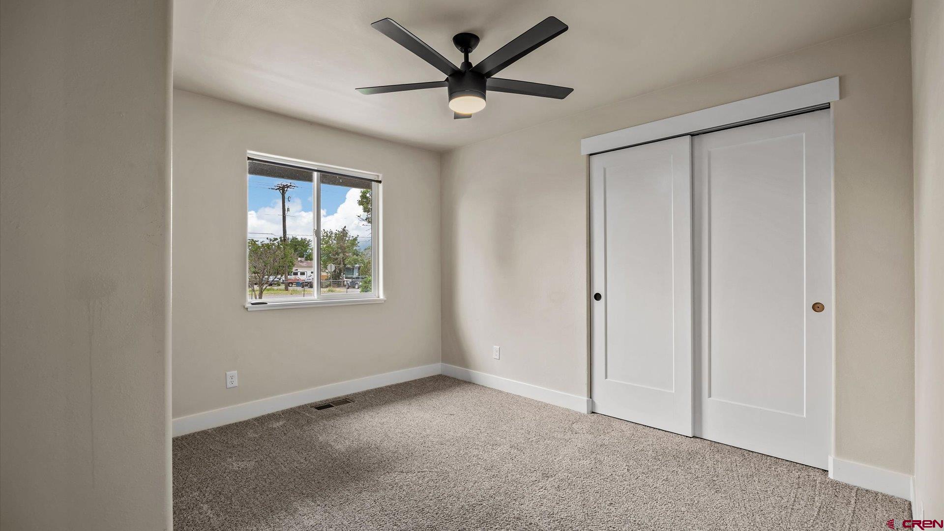 3312 East 1/4 Road Clifton, CO 81520 - Photo 28 of 43 a view of a livingroom with a ceiling fan and window