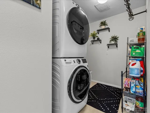 a large white kitchen with a sink and dishwasher a refrigerator with white cabinets