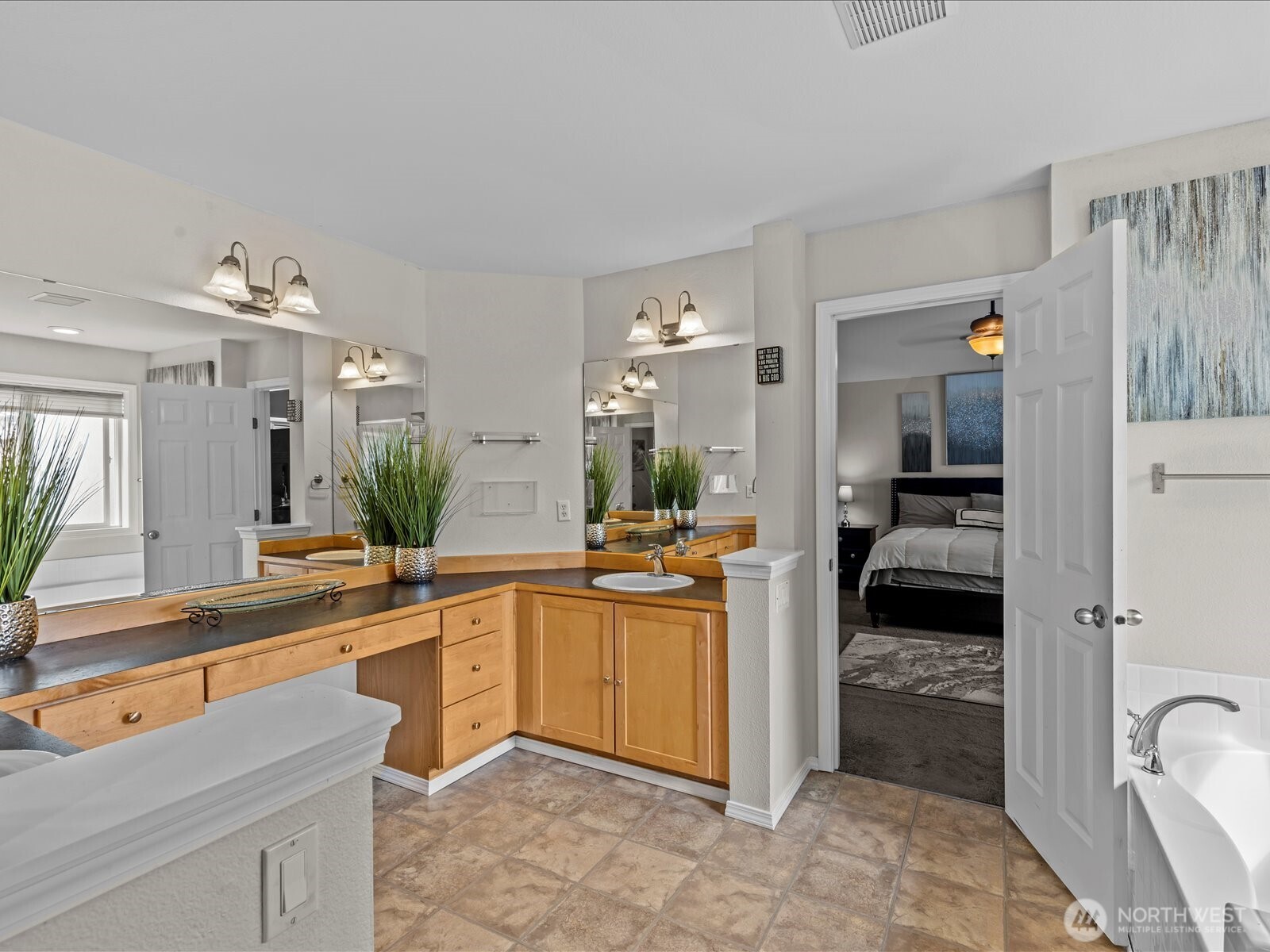 27450 237th Place Southeast Maple Valley, WA 98038 - Photo 27 of 36 a large white kitchen with a large window and stainless steel appliances