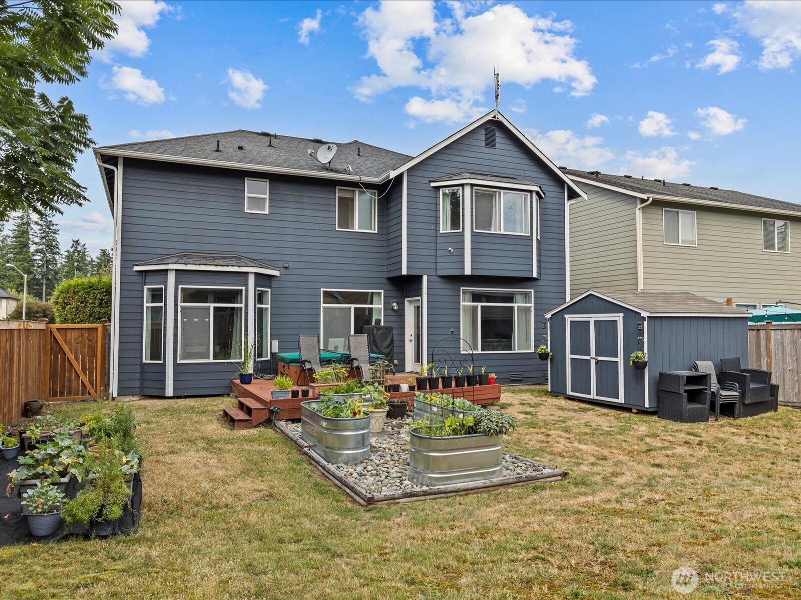 27450 237th Place Southeast Maple Valley, WA 98038 - Photo 33 of 36 a front view of a house with yard porch and furniture