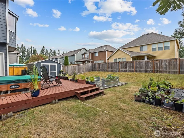 an aerial view of a house with swimming pool patio and outdoor seating