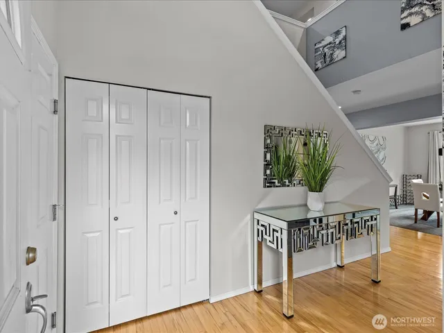 a view of entryway and hall with wooden floor