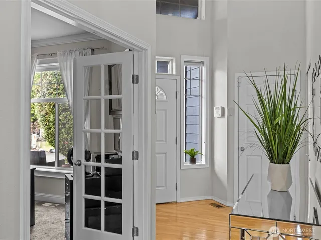 a view of a hallway with wooden floor and entryway