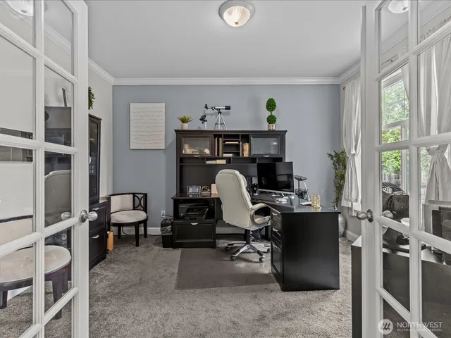 a view of a workspace with furniture and a window