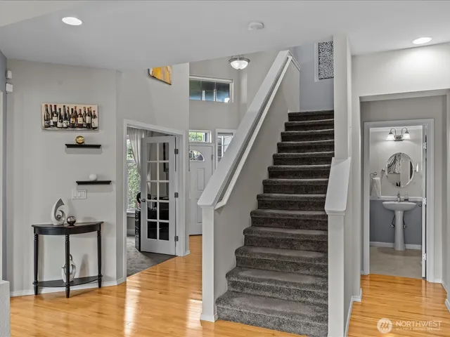 a view of a hallway with wooden floor and entryway