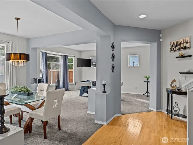 a living room with furniture a rug and a table