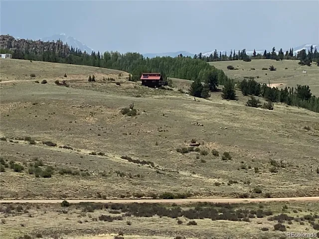 a view of a dirt road with a building