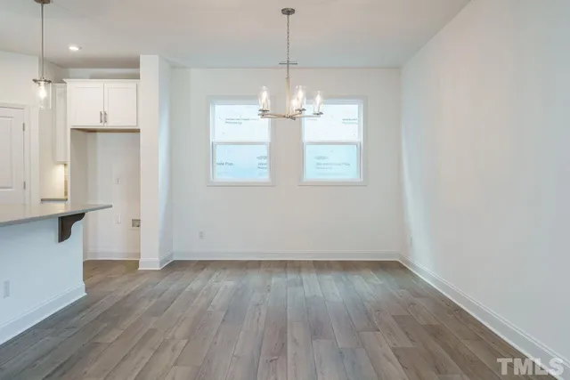 a view of kitchen and dining room with wooden floor
