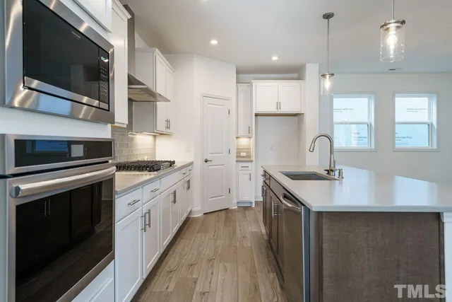 a kitchen with a sink stove and microwave