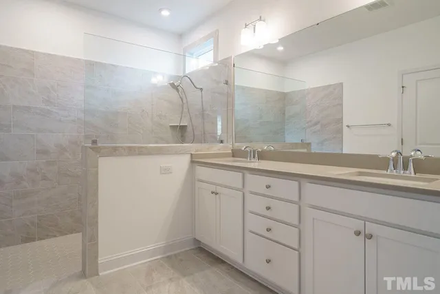 a bathroom with a granite countertop sink mirror and double