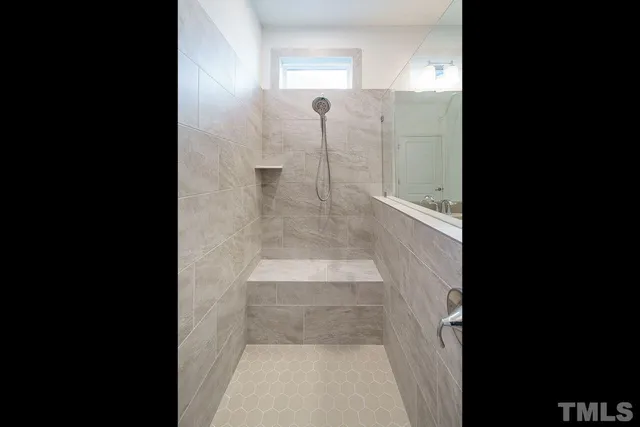 a bathroom with a glass shower door