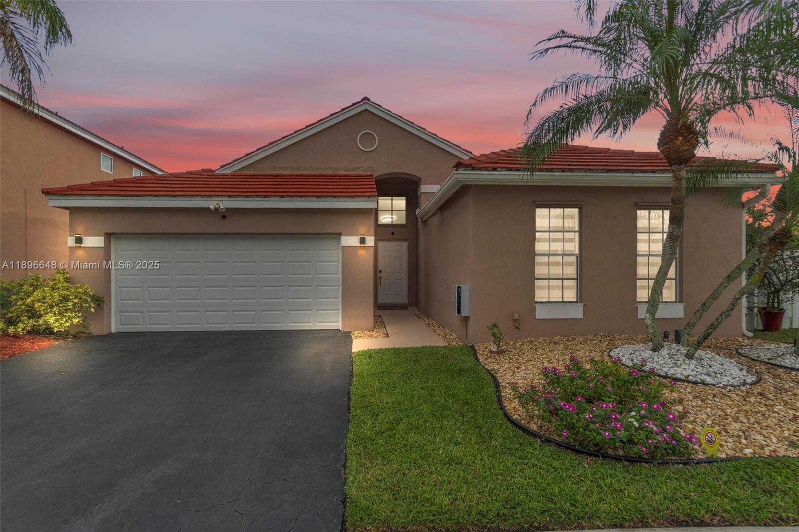 a front view of a house with a garden