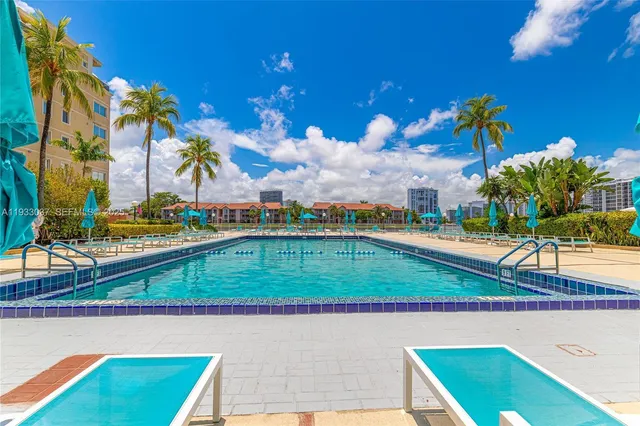 a view of a living room with a tub and large windows