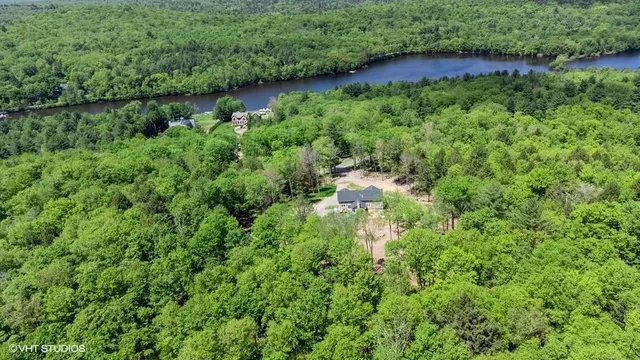 an aerial view of residential house with outdoor space and trees around