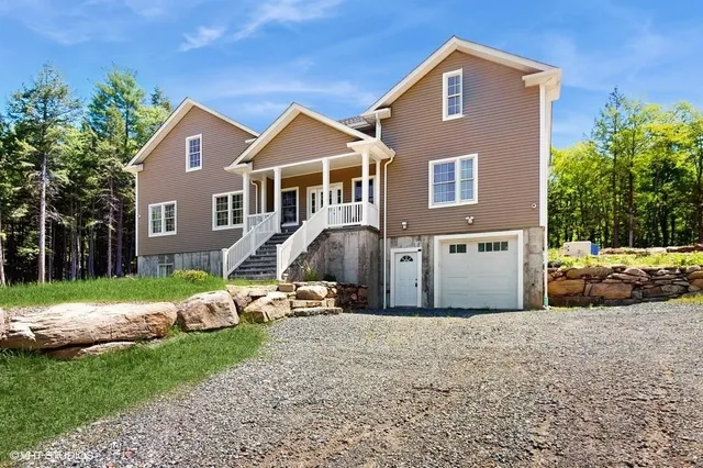 a front view of a house with a yard