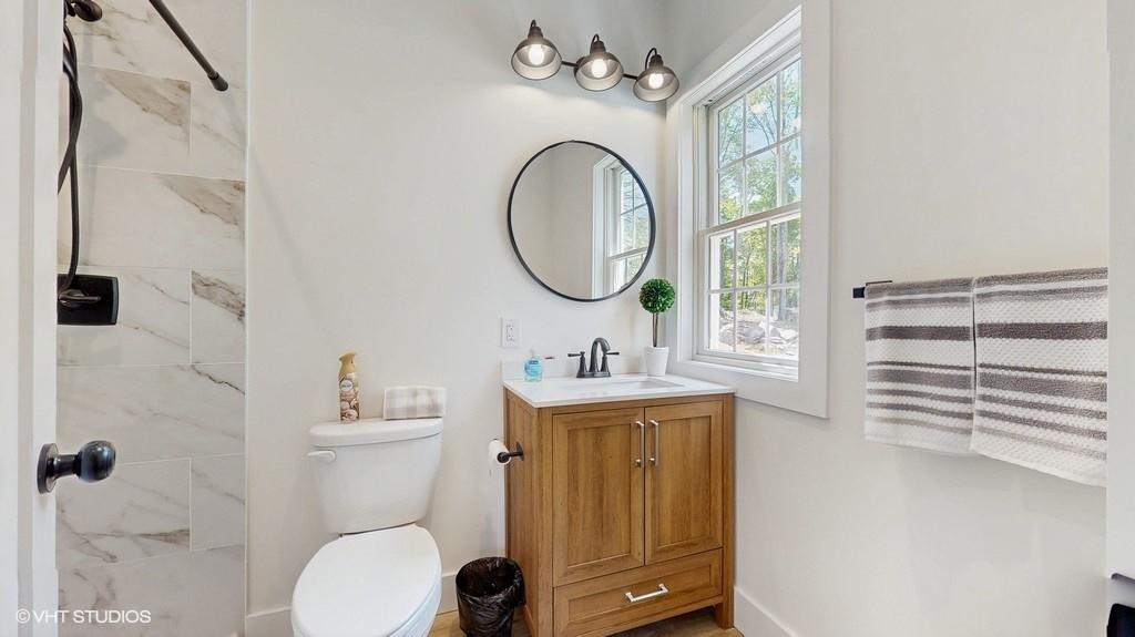 836 Starlight Road Monticello, NY 12701 - Photo 27 of 50 a bathroom with a toilet a sink and a mirror