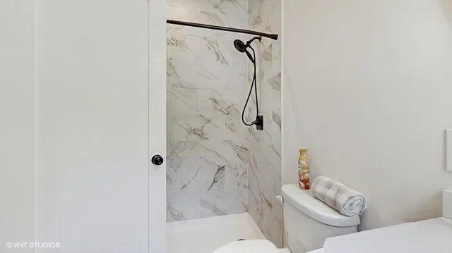 a white bath tub sitting next to a toilet