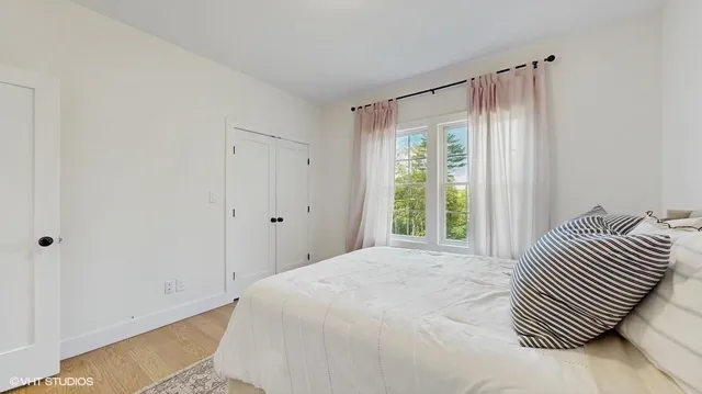 a bedroom with a bed and a window