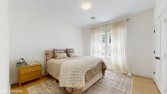 a room with a bed and window