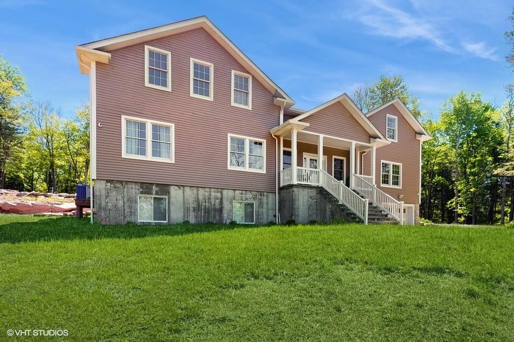 836 Starlight Road Monticello, NY 12701 - Photo 5 of 50 a front view of a house with a yard and garage