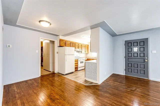 a kitchen with granite countertop a refrigerator a sink and dishwasher