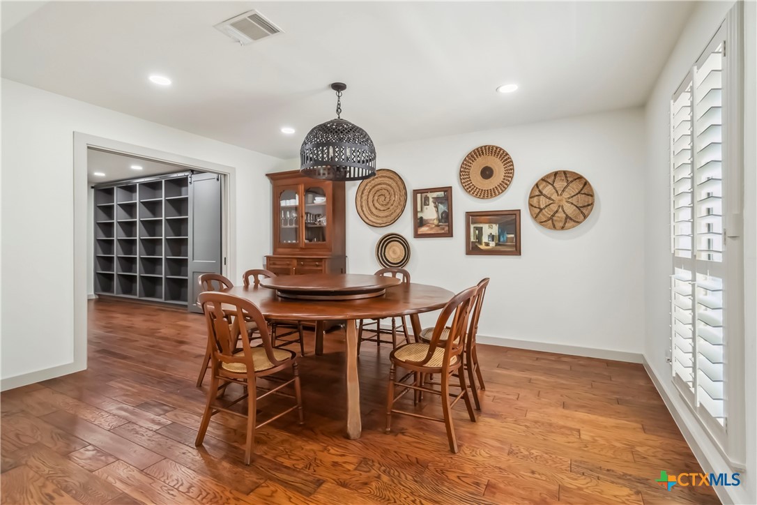 425 West Edgewater Terrace New Braunfels, TX 78130 - Photo 13 of 45 a view of a dining room with furniture window and wooden floor