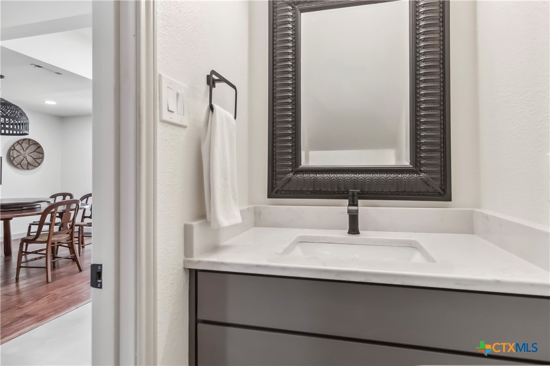 425 West Edgewater Terrace New Braunfels, TX 78130 - Photo 17 of 45 a bathroom with a sink and a mirror