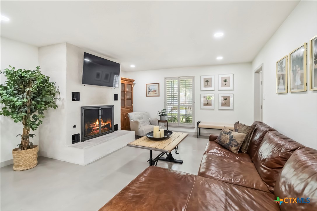 425 West Edgewater Terrace New Braunfels, TX 78130 - Photo 2 of 45 a living room with furniture and a fireplace