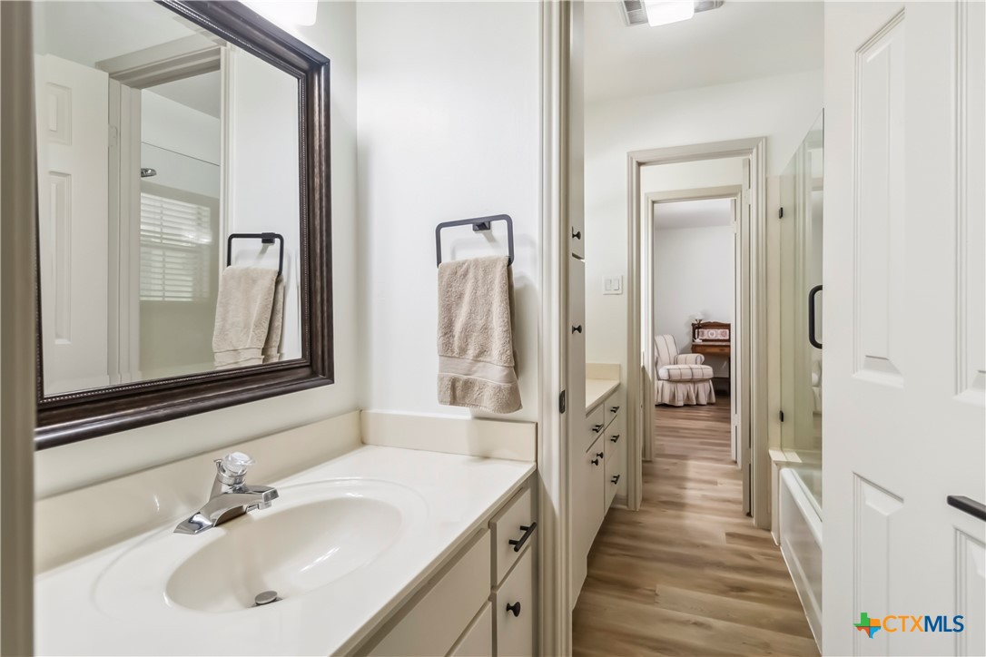 425 West Edgewater Terrace New Braunfels, TX 78130 - Photo 26 of 45 a en suite bathroom with a sink mirror and a shower